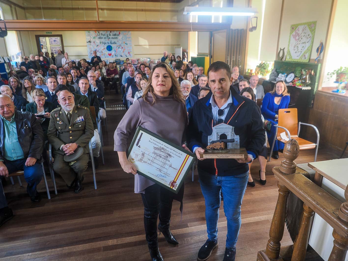 Beatriz Herrera, miembro de la asociación, entrega la distinción a Ramón Juntadez, responsable de Operaciones de la empresa TKV Logística Cantabria.