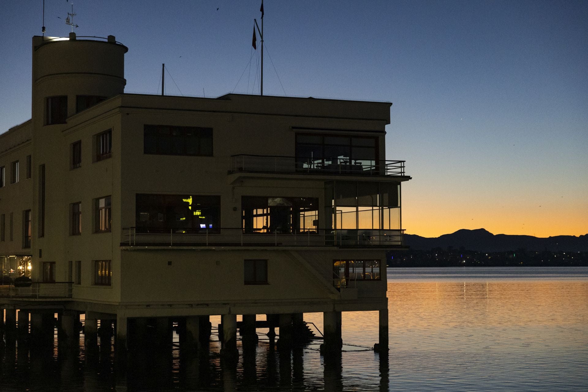 La noche y el día envuelven al tiempo el edificio del Club Marítimo