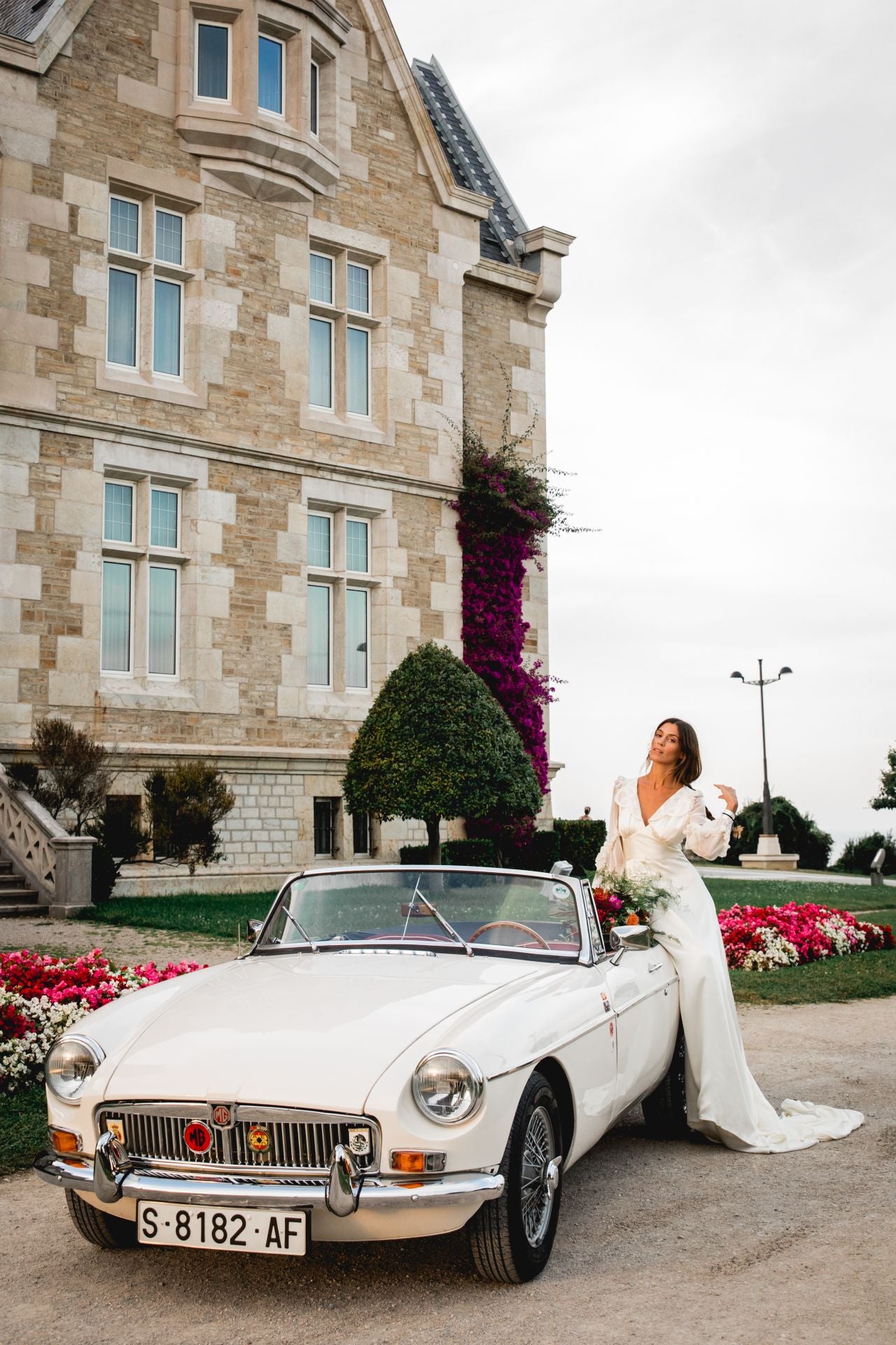 La influencer Lucía Páramo, con vestido de Alma Aguilar, flores de Marta Azpeitia y coche clásico by Nacho de Villota. 