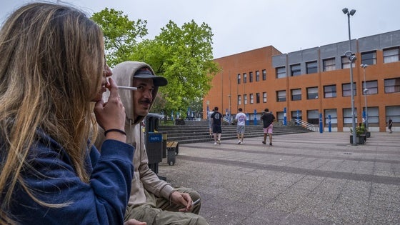 Dos estudiantes fuman a las puertas de la biblioteca del edificio Interfacultativo de la Universidad de Cantabria.