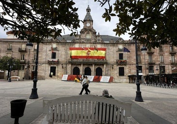 Vecinos caminan frente al Palacio municipal de Torrelavega, en el Bulevar Demetrio Herrero.