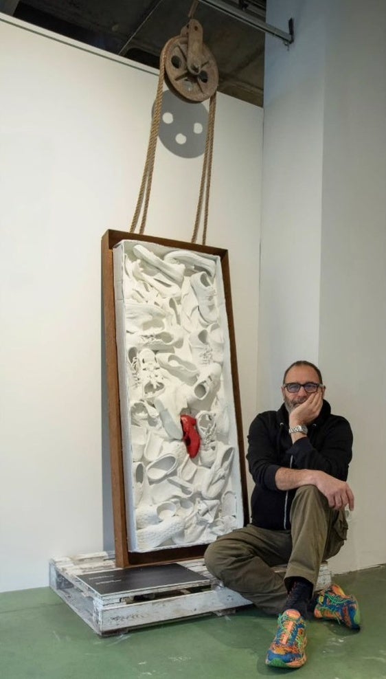 El artista Juanma Tapia juntos a su obra «Carnemigrante, por cuartos o enteros»