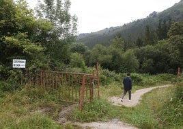 Un hombre camina por los terrenos afectados por el coto y la ruta familiar, en La Montaña.