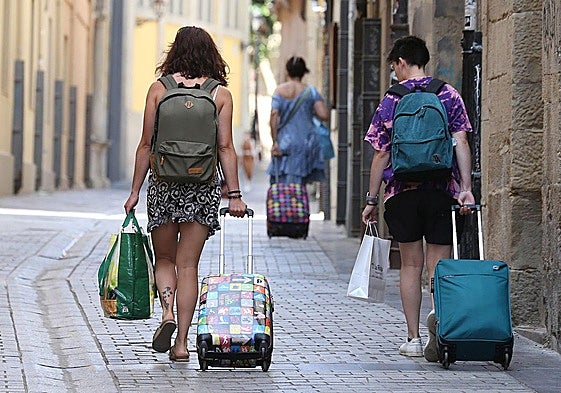 Varias personas a su salida de una vivienda de uso turístico.