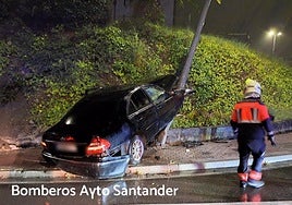 Los bomberos de Santander asisten al vehículo impactado contra un talud y una farola, en la S-20.