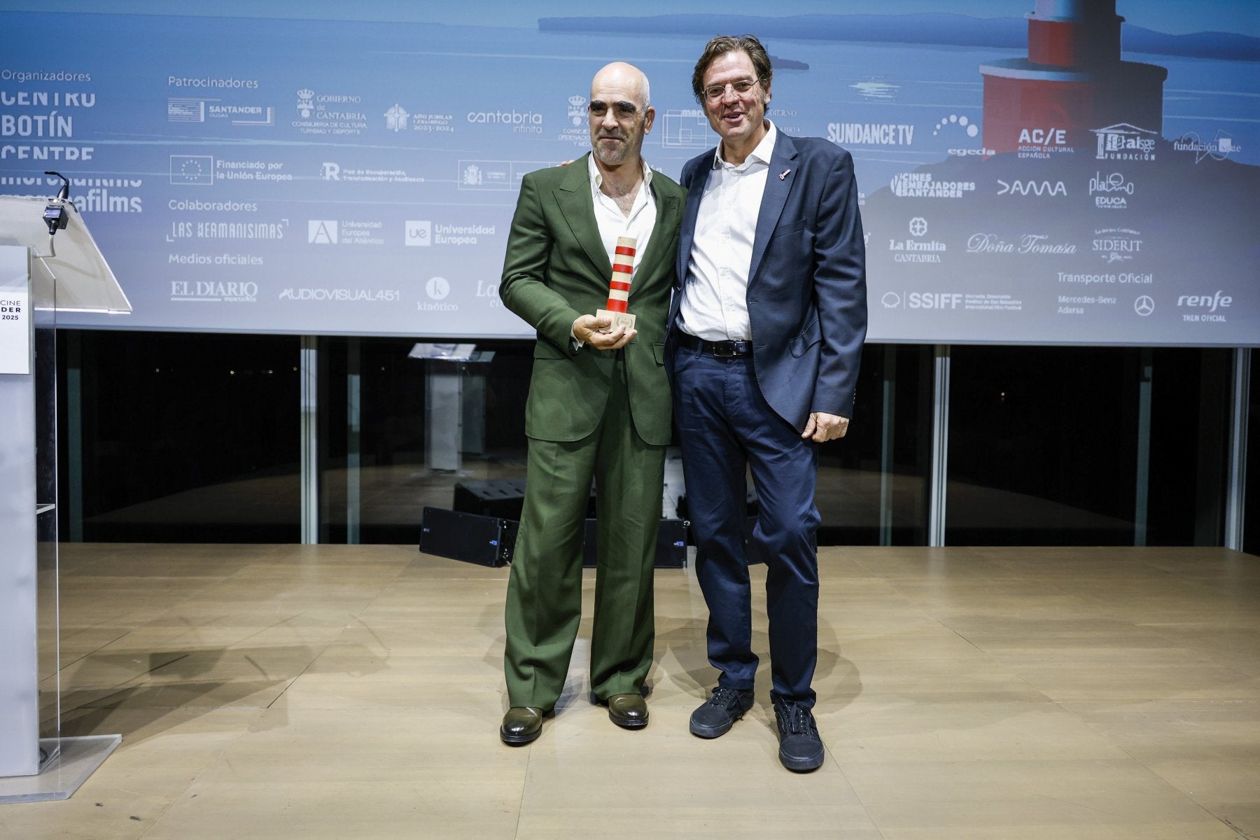 El actor Luis Tosar, con su Faro de Honor, junto a Álvaro Longoria.