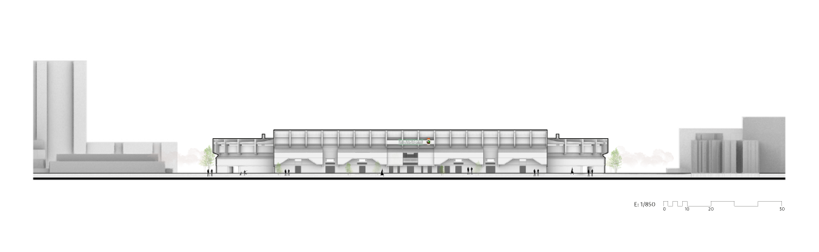 Imagen antes - Se ampliaría con un nuevo edificio que sefundirá con el actual creando una sola unidad funcional, aunque estructuralmente sería la nueva estructura la que soportara todo el peso de las nuevas gradas (el tercer nivel). Actualmente es el acceso al terreno de juego y sede social del club, donde se encuentran el escudo y nombre de la sociedad y las banderas.