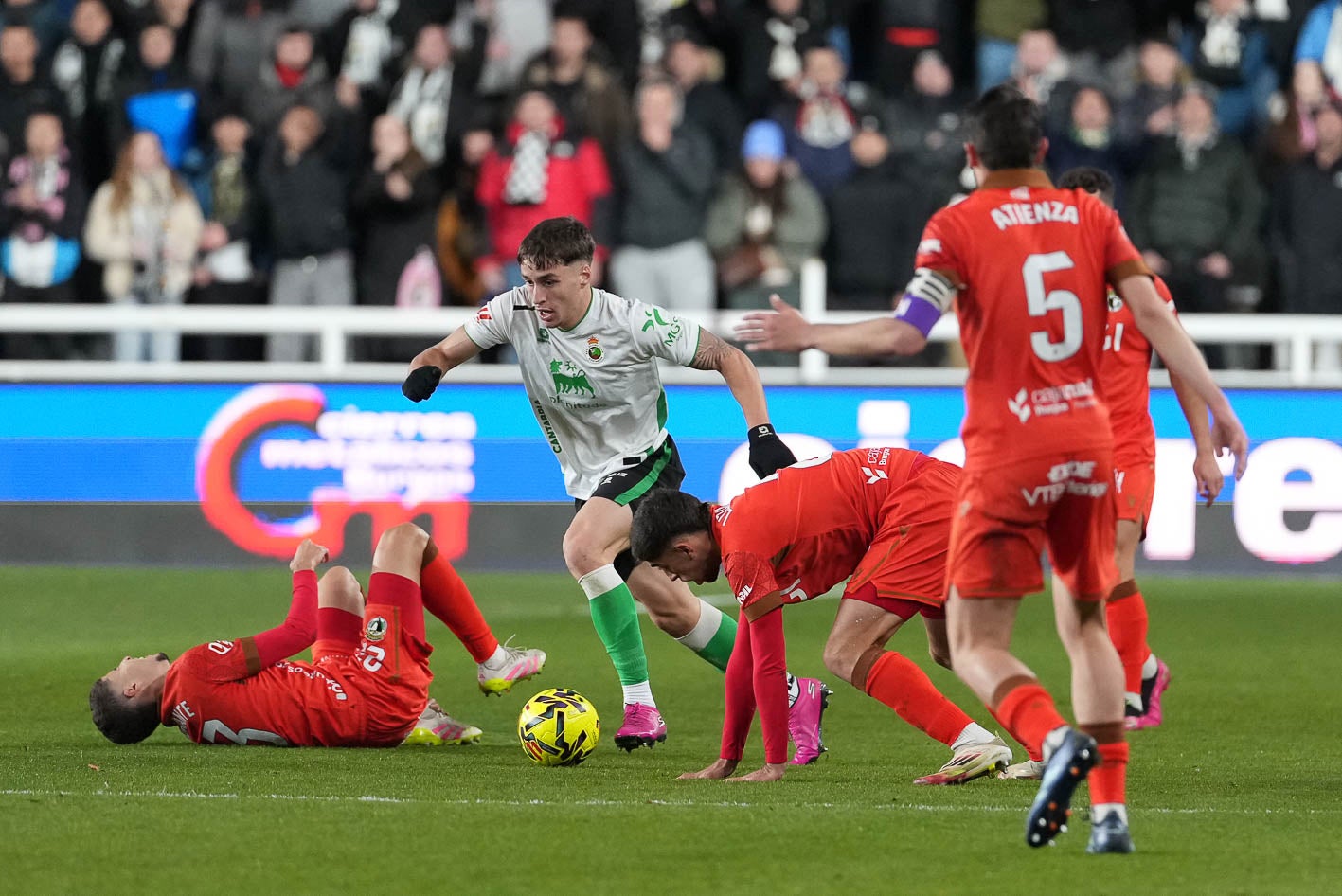 Salinas avanza con el balón entre jugadores del Burgos. 