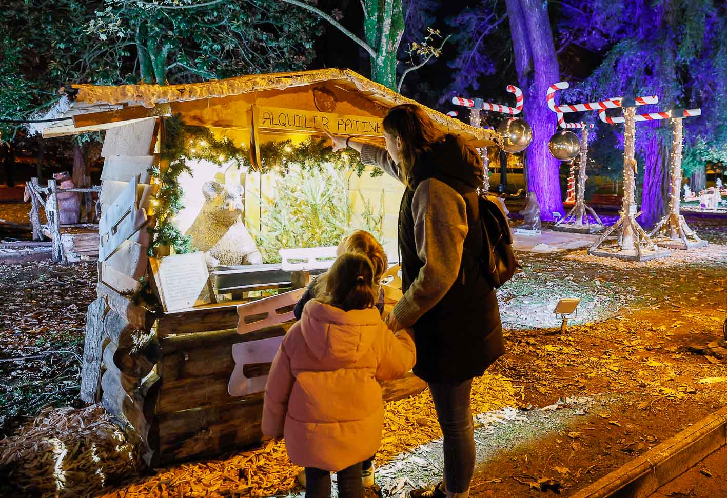 Una madre y su hija observan un puesto navideño.