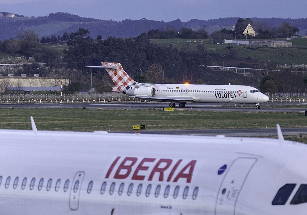 Un avión de Iberia en primer plano y, al fondo, otro de Volotea en el aeropuerto Seve Ballesteros.