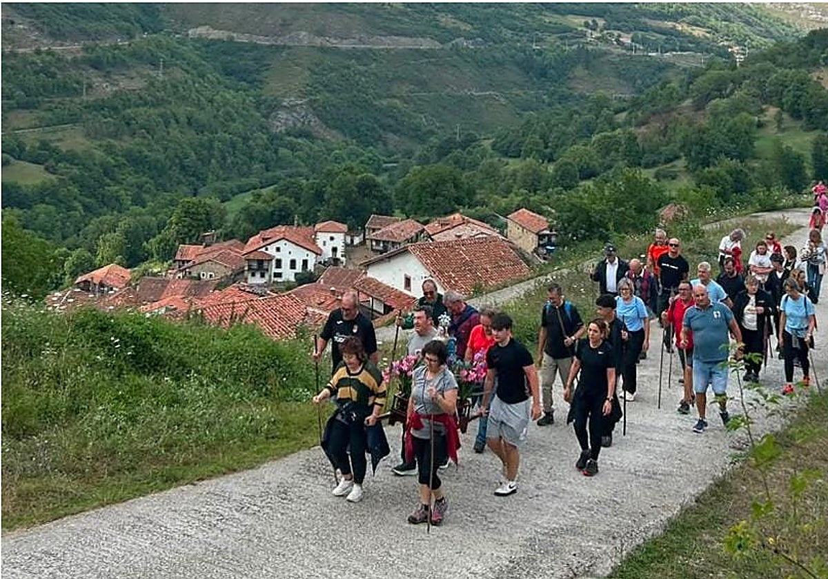 Procesión con la imagen de la Virgen de las Nieves y el pueblo de Tudanca al fondo.