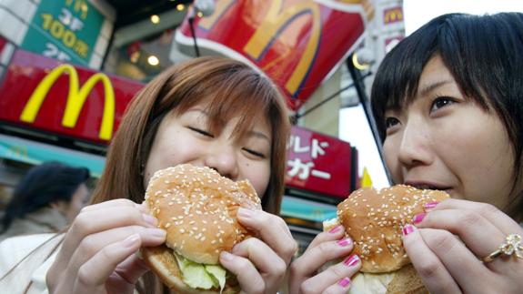 Dos adolescentes disfrutan de sendas Big Mac´s en Tokio. 