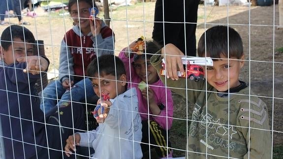 Los niños pasan los días detrás de la alambrada, esperando.