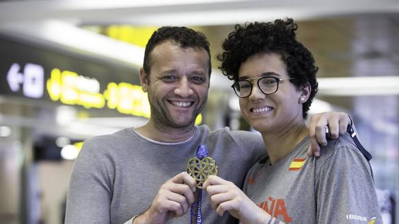 Laura Nicholls muestra sonriente su medalla de oro europea junto a su padre, Alfonso, este martes en el aeropuerto Seve Ballesteros