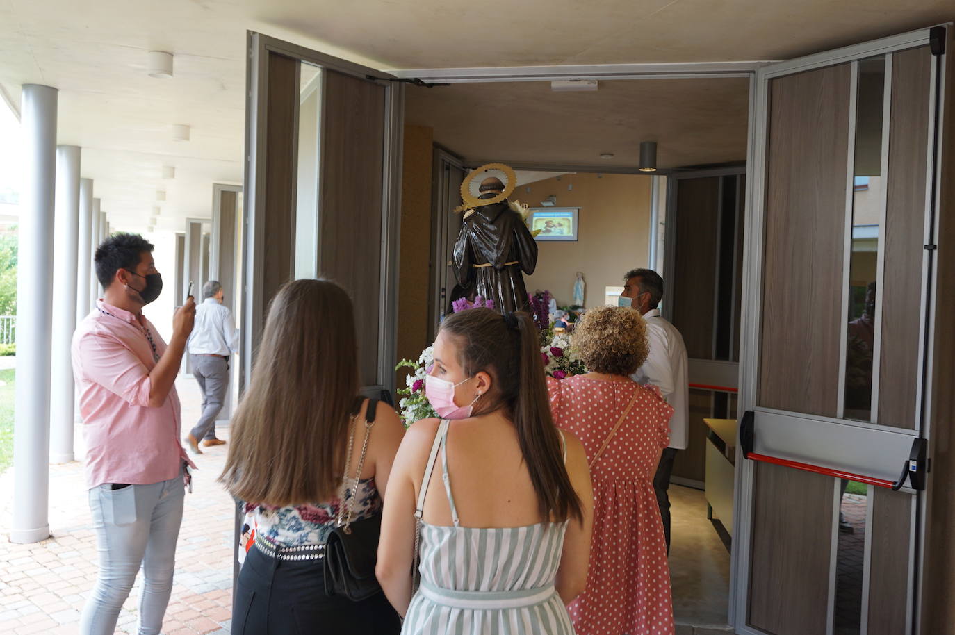 La familia Villarreal posa delante de la talla de San Antonio instantes previos a realizar la ofrenda floral. 