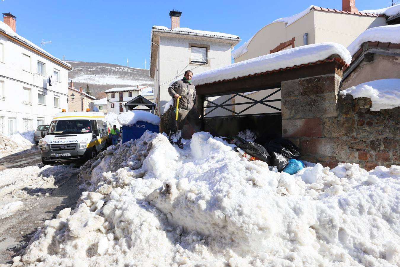 Un operario recoge basura enterrada por la nieve en Barruelo.