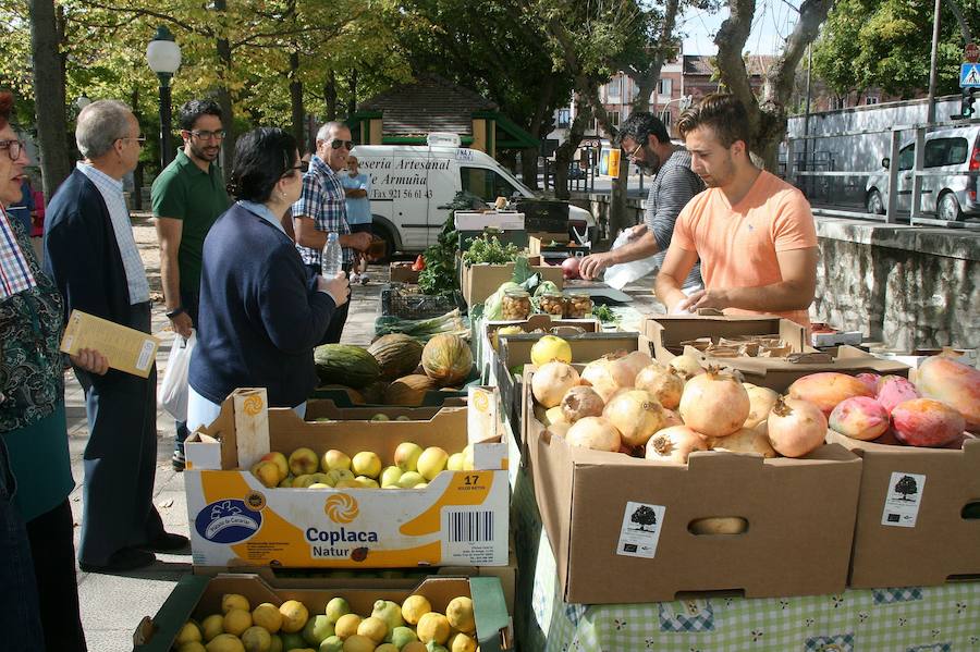 El público compra productos en uno de los puestos del mercado.