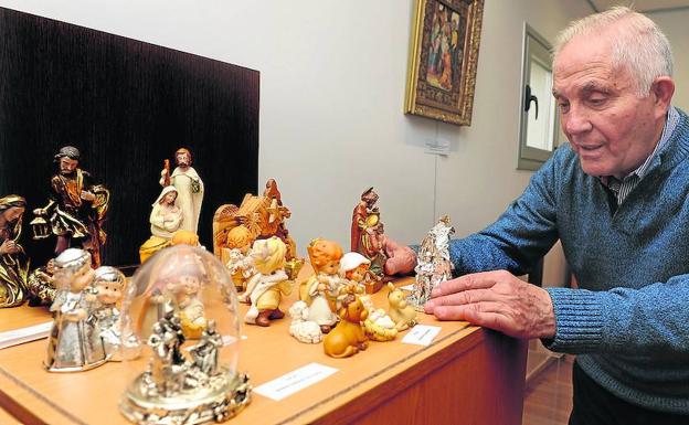 El sacerdote Miguel Gallego García, junto a parte de su exposición de nacimientos.