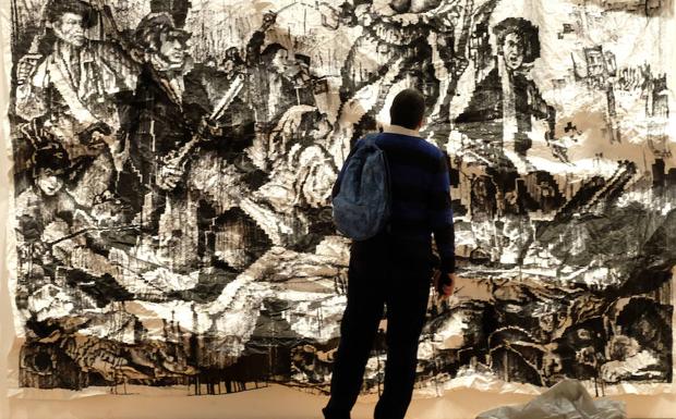 Un hombre contempla la obra deJavier Arce 'La libertad guiando al pueblo'. Ramón Gómez