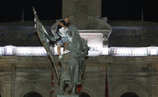 Un peñista retira la pañoleta de la estatua del Conde Ansúrez con motivo del fin de las fiestas.