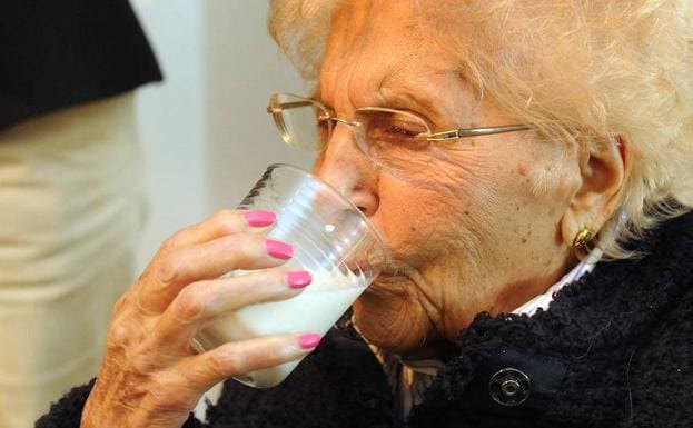 Anciana bebiendo leche de burra. 