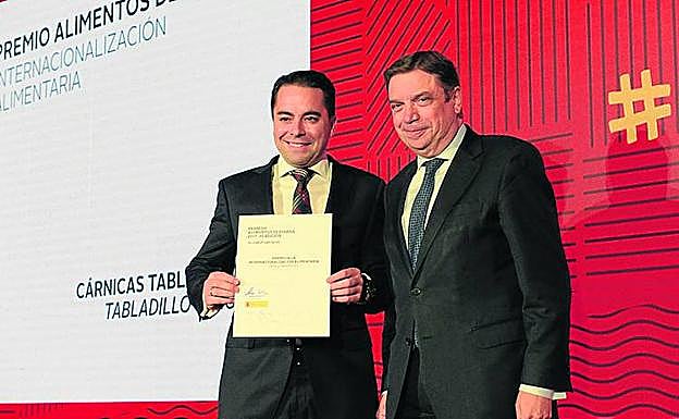David de María muestra el premio en presencia del ministro. 