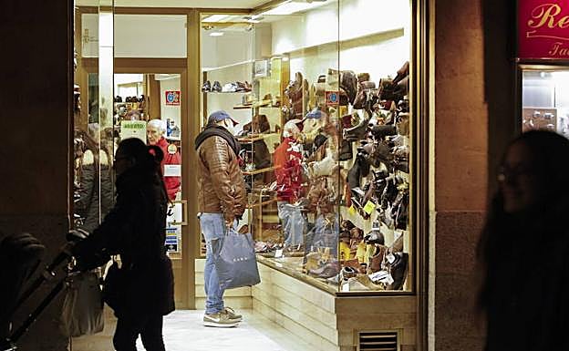 Posibles clientes a las puertas de un comercio en Salamanca. 