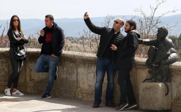 Turistas se hacen un selfi con el diablillo de San Juan. 