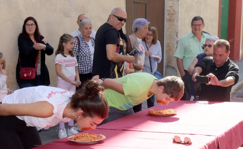 Participantes en el concurso de comer sin manos en el barrio de Pilarica de Valladolid.