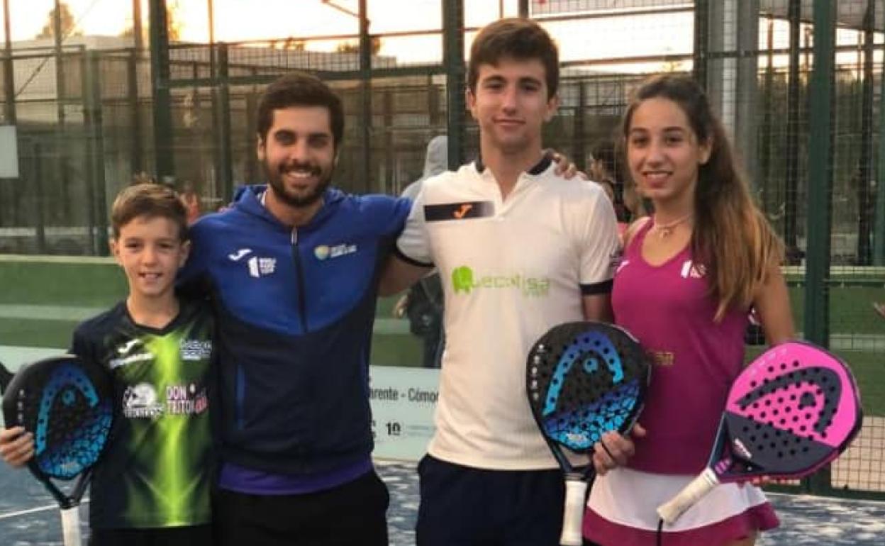 El entrenador posa con sus tres pupilos. 