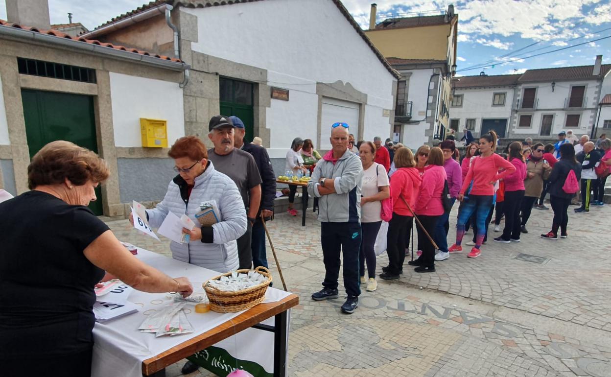 Vecinos de Los Santos recogen sus dorsales.