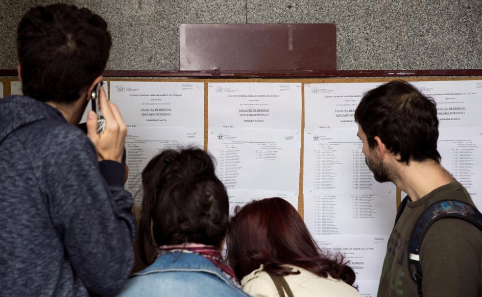 Opositores se buscan en unas listas, el pasado 19 de octubre, cuando se celebró el primer proceso de selección para cubrir 8.102 plazas en la Administración general.