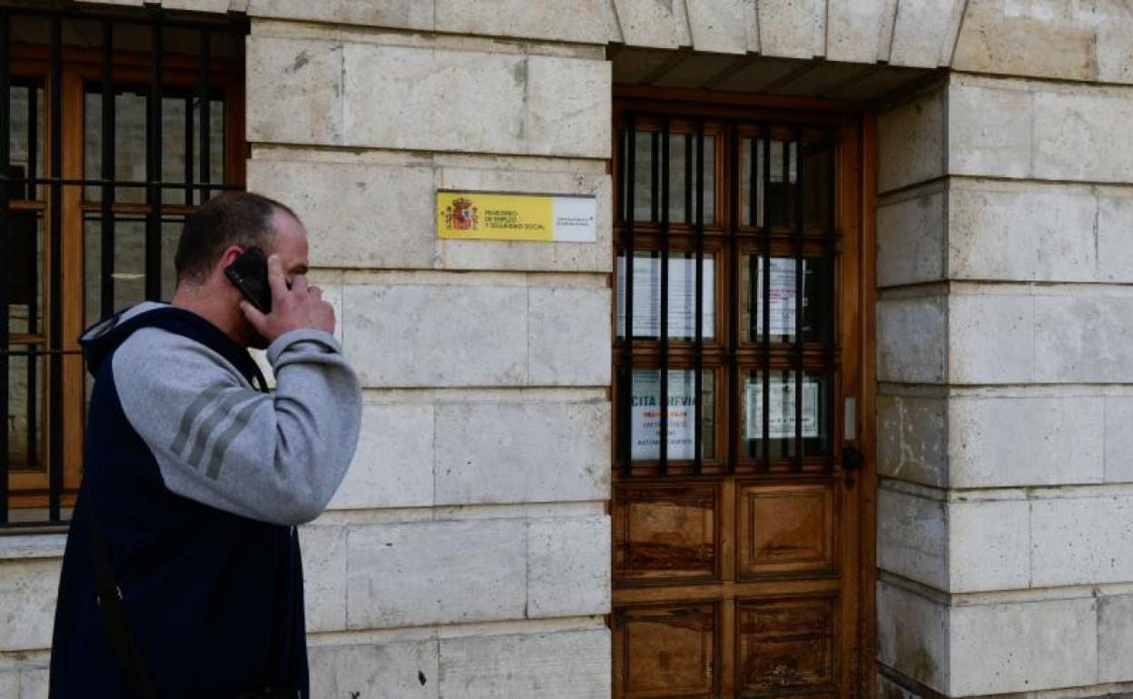 Un hombre habla por teléfono a la puerta de una oficina del Ecyl - Sepe.