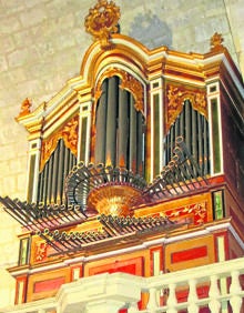 Imagen secundaria 2 - Arriba, tradicionales viviendas porticadas de la localidad; abajo, pila bautismal del siglo XIII que se conserva en la iglesia de Santa Columba y órgano de finales del siglo XVIII que ha sido restaurado. 
