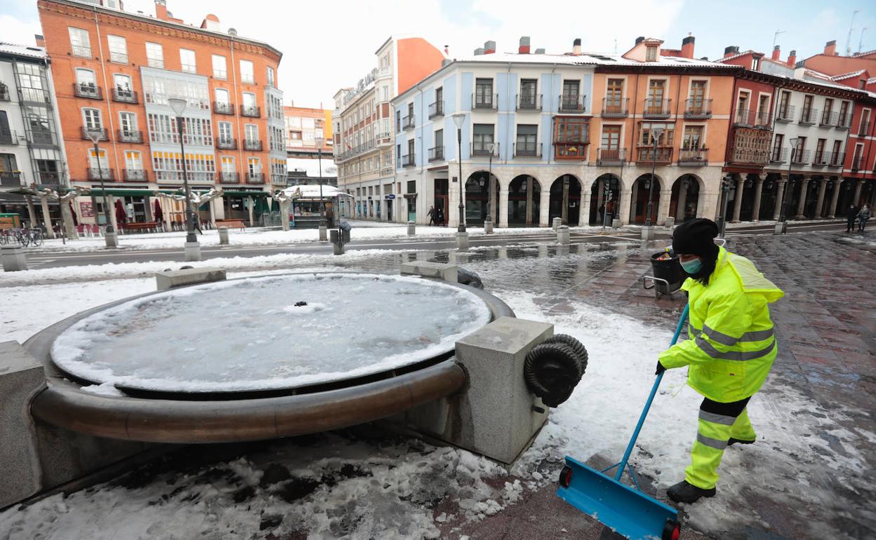 Un operario del Ayuntamiento de Valladolid limpia este domingo el hielo en el centro de la ciudad.