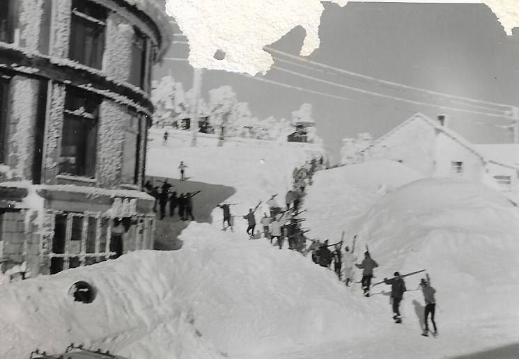 Fila de esquiadores subiendo al alto de Navacerrada deslizarse por sus laderas. 