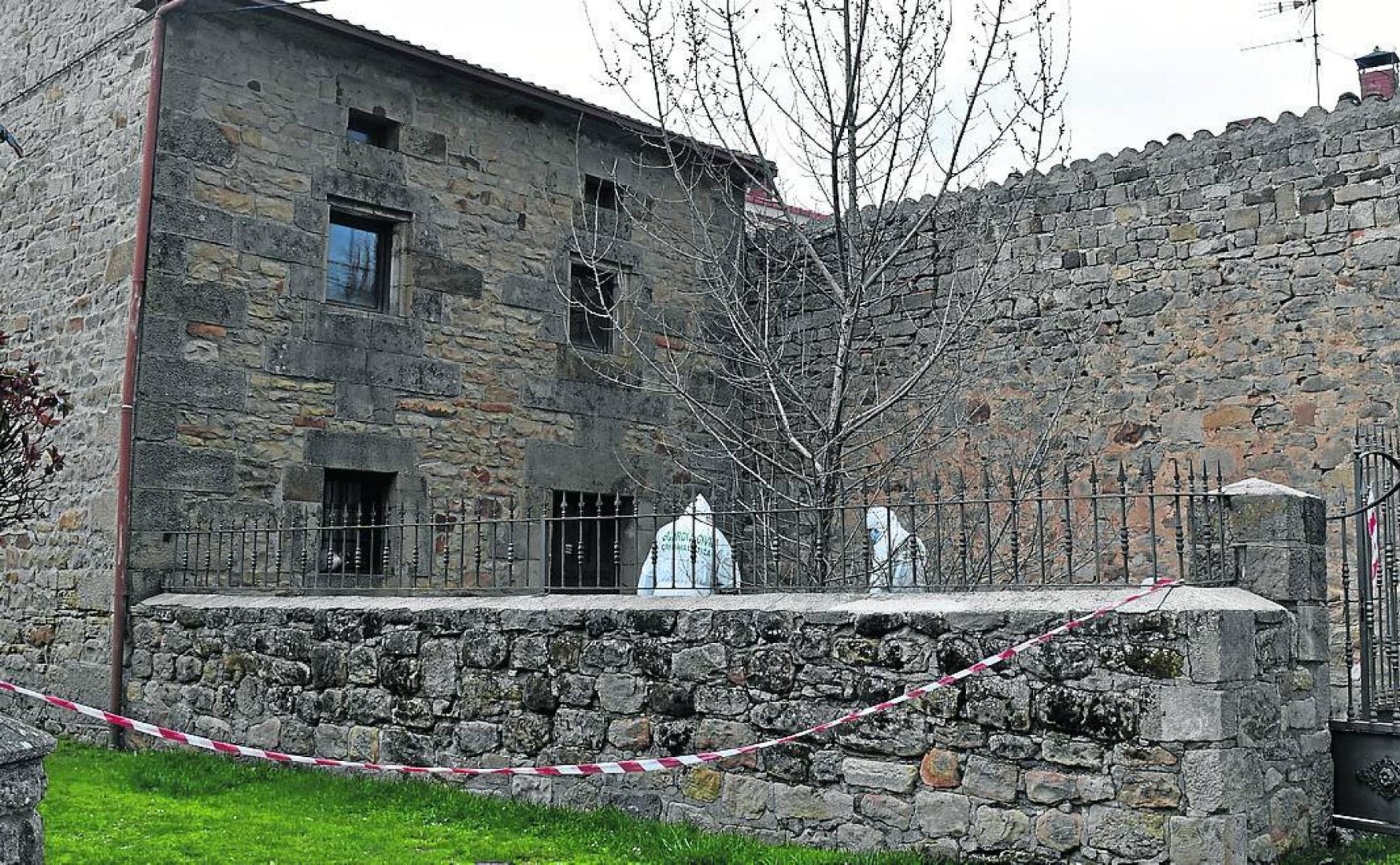 Los agentes de la Policía Científica rastrean el patio de una de las viviendas.