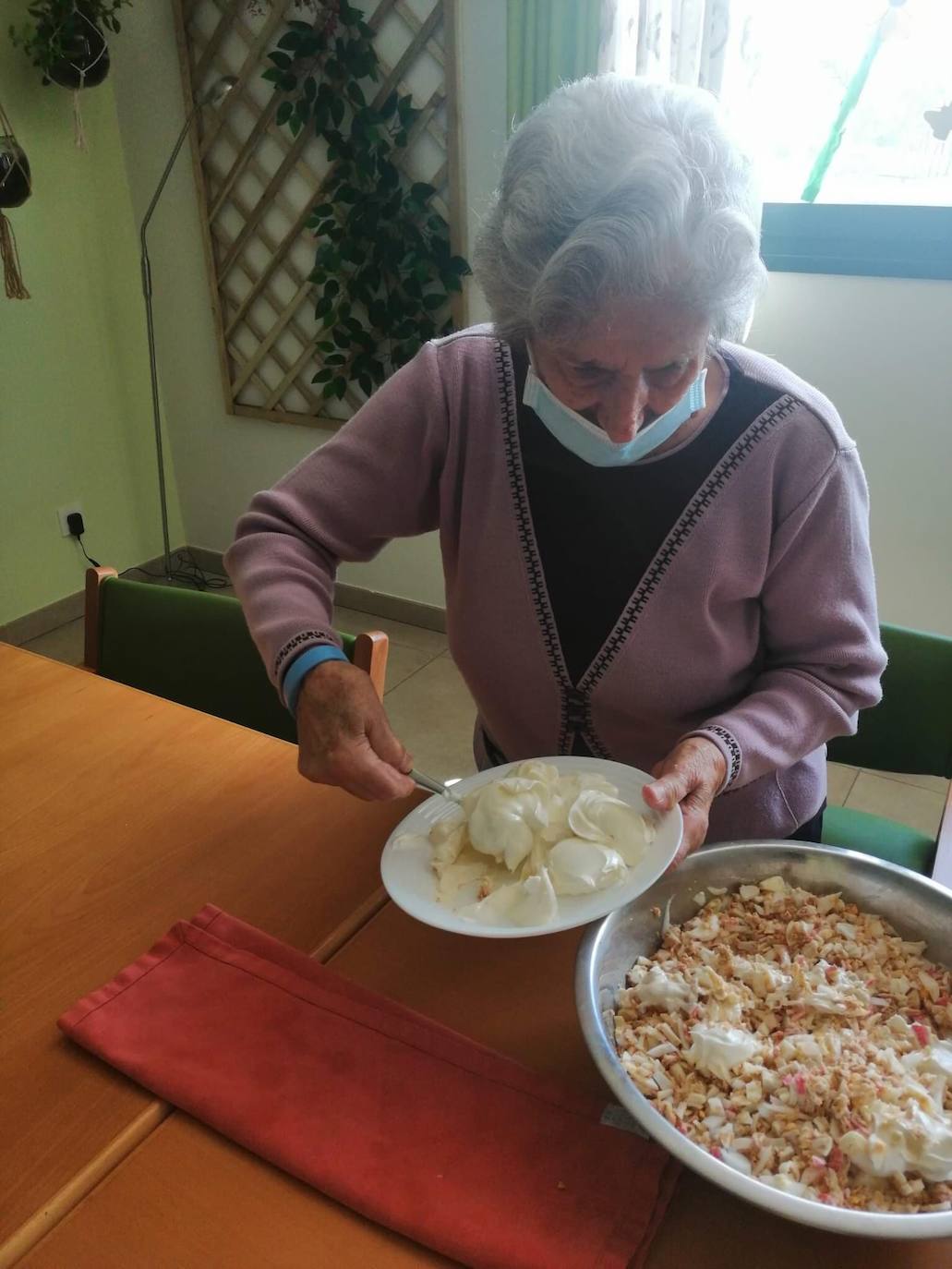Un grupo de mayores de Adanda de Duero colaboran en la preparación de un canapé.