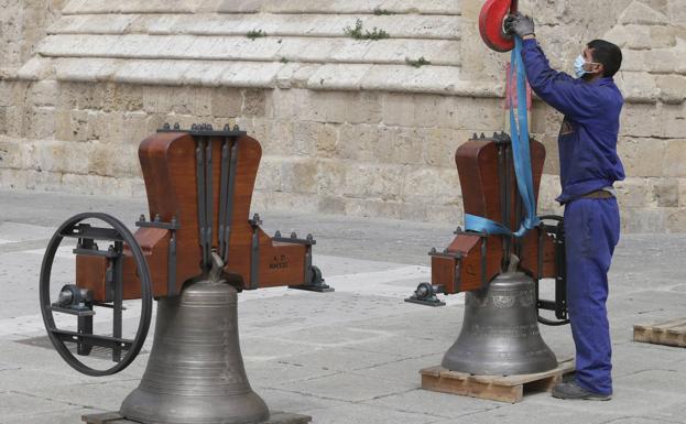 Un trabajador prepara una campana para subir en la grúa a la Catedral.