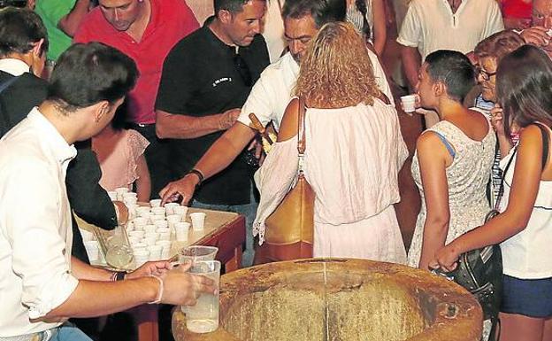 Los palentinos recogen vasos de agua en la fiesta del santo.