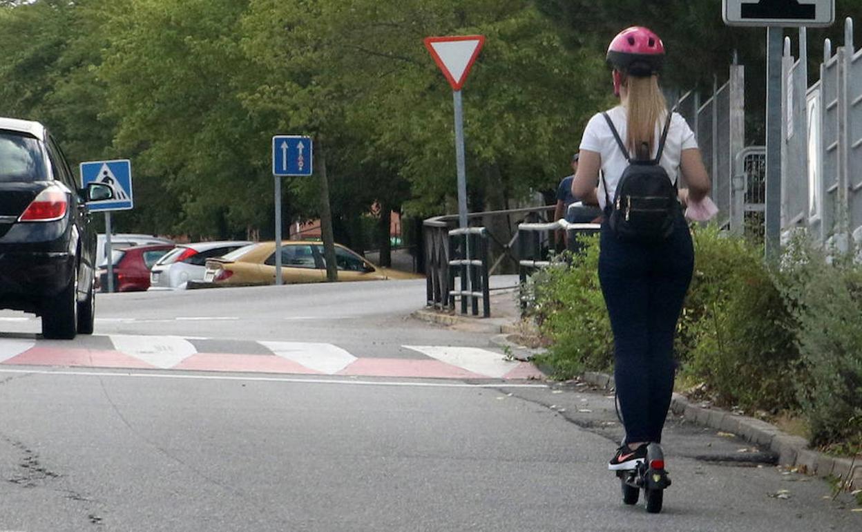 Una joven en patinete eléctrico en la calle Gerardo Diego. 