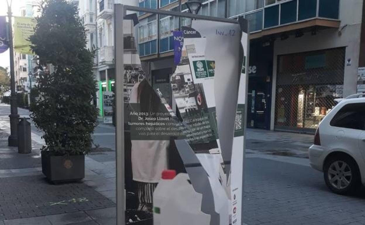 Uno de los paneles de la muestra de la Asociación Contra el Cáncer destrozado en la calle Santiago.