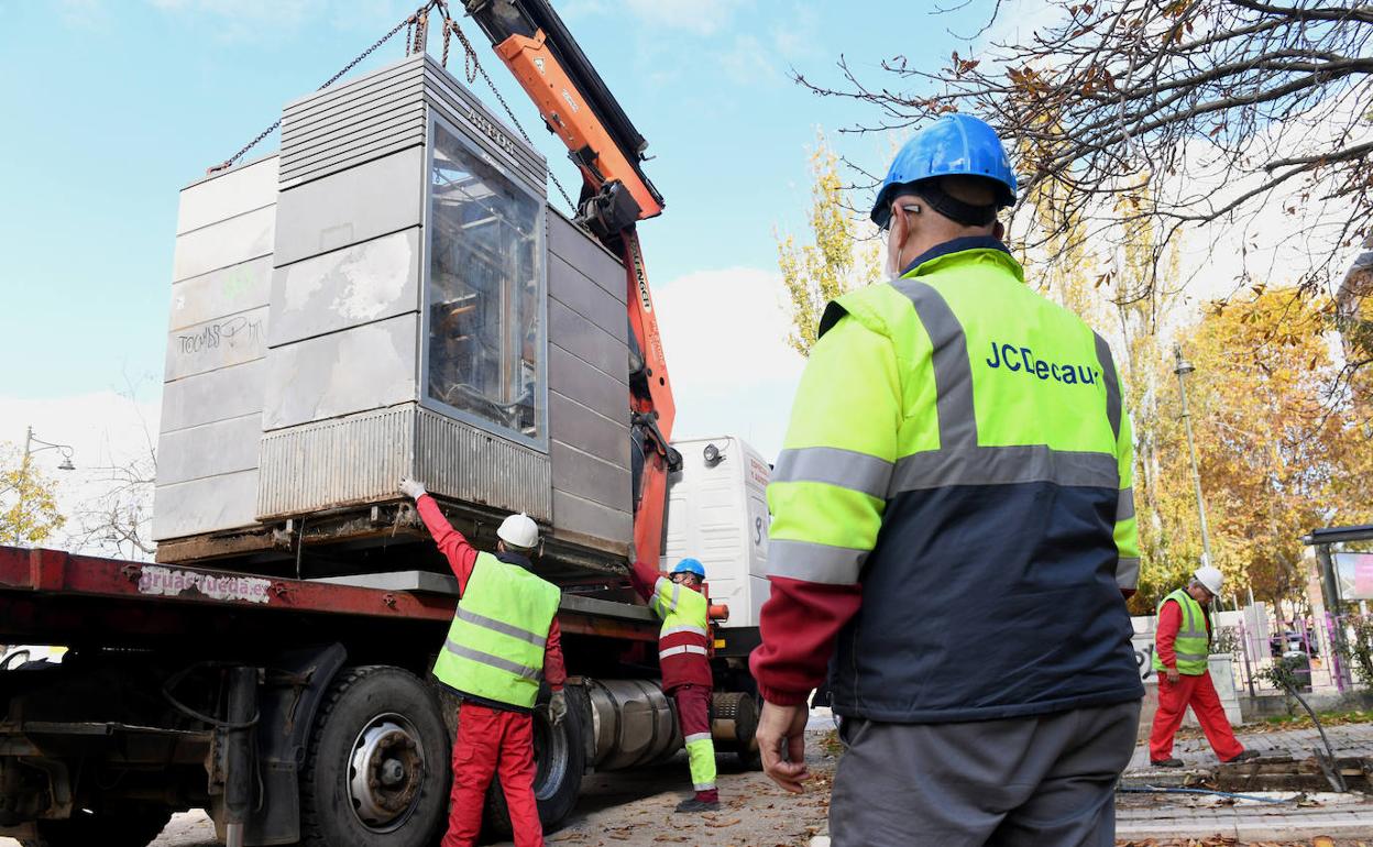 Técnicos de la empresa JCDecaux retiran el aseo público de la plaza de Poniente para la instalación de la nueva cabina. 