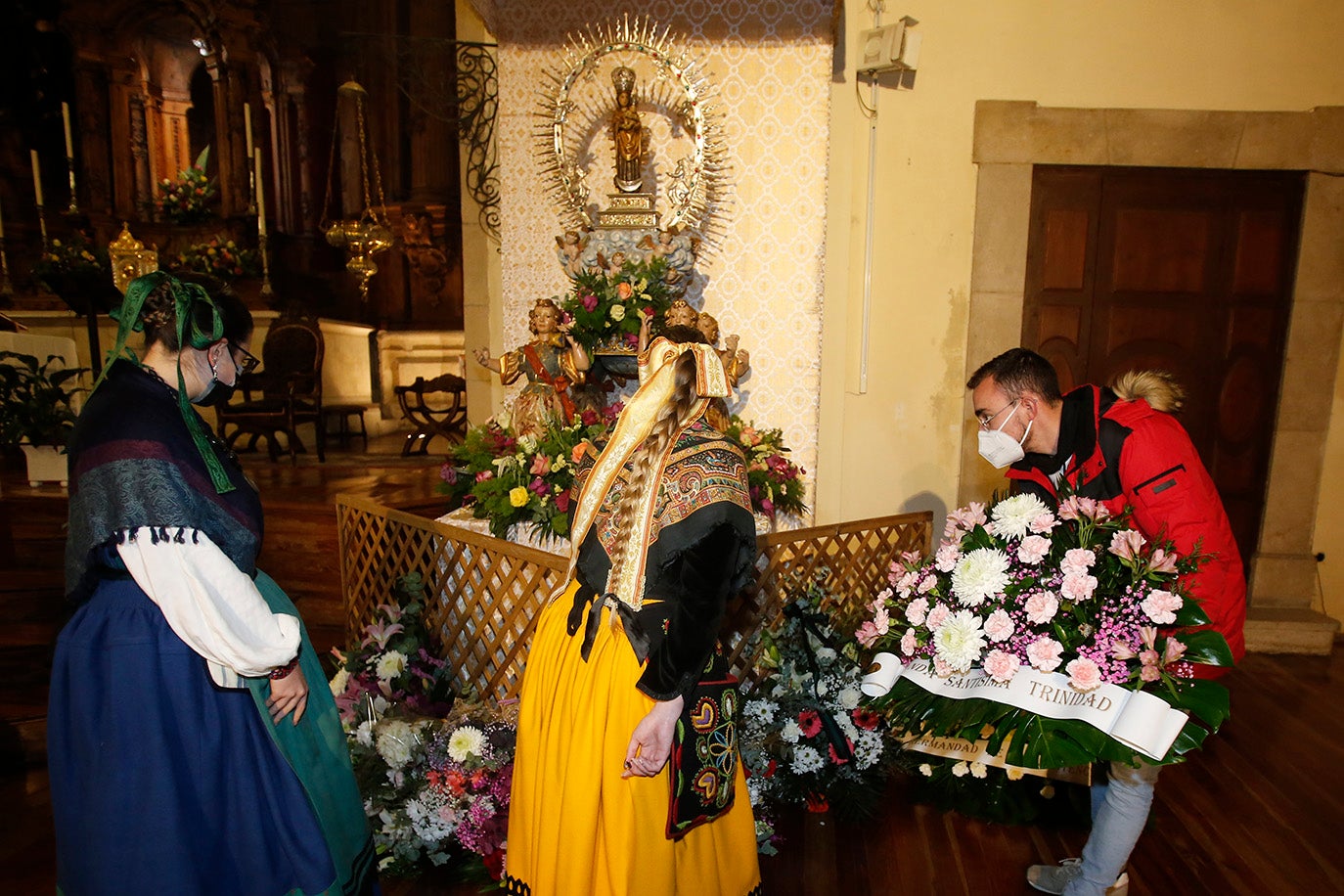 Los palentinos dejan sus flores a la Virgen la Calle en la iglesia de La Compañia