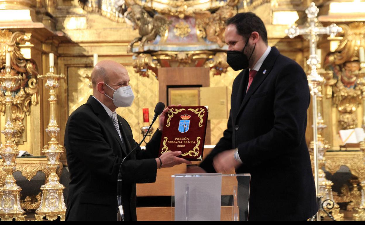 Juan Antonio del Barrio recibe las cubiertas del pregón de manos del presidente de la Junta de Cofradías, Víctor García. 