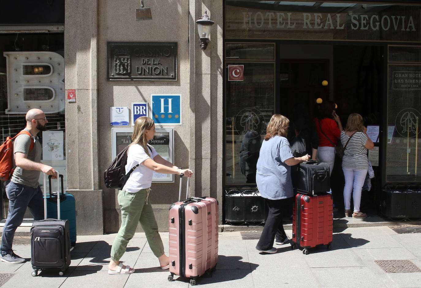 Turistas llegan a un hotel de Segovia.