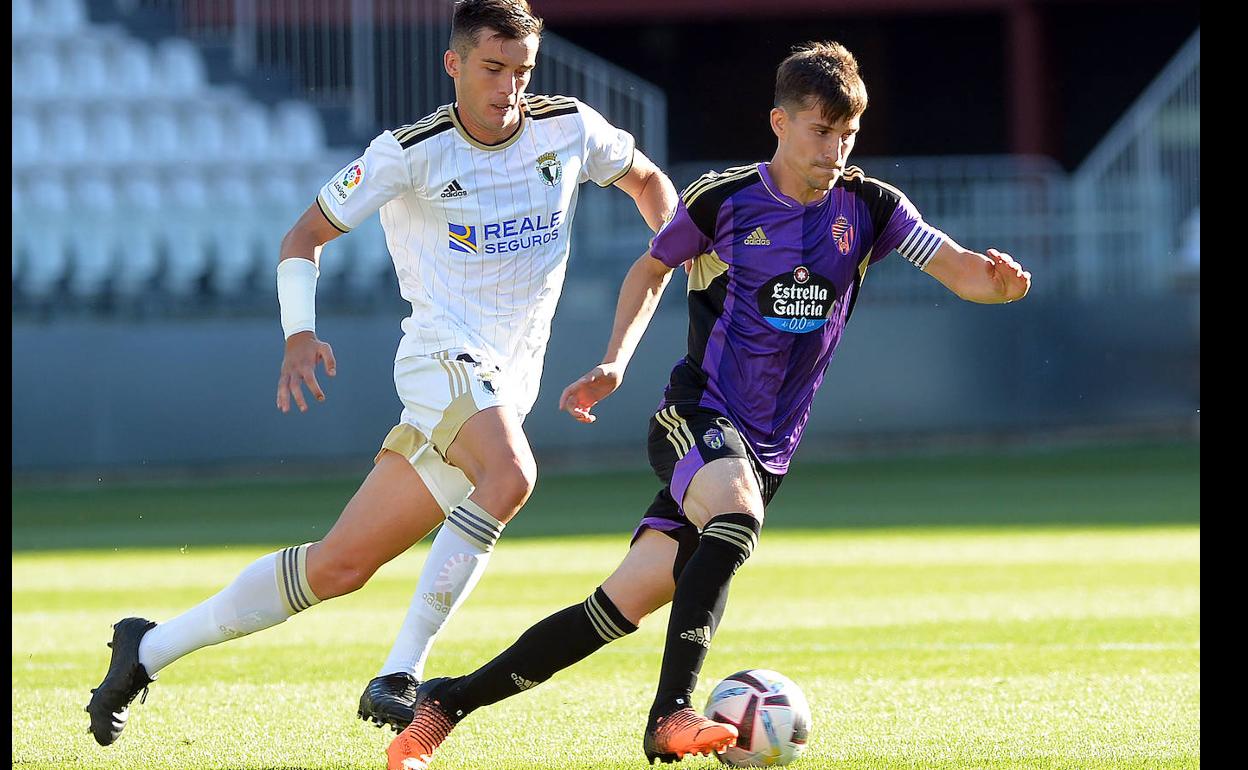 Toni Villa, capitán ante el Burgos, perseguido por un rival en El Plantío. 