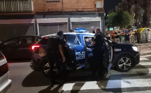 Agentes de la Policía Nacional introducen al detenido en un vehículo policial. 