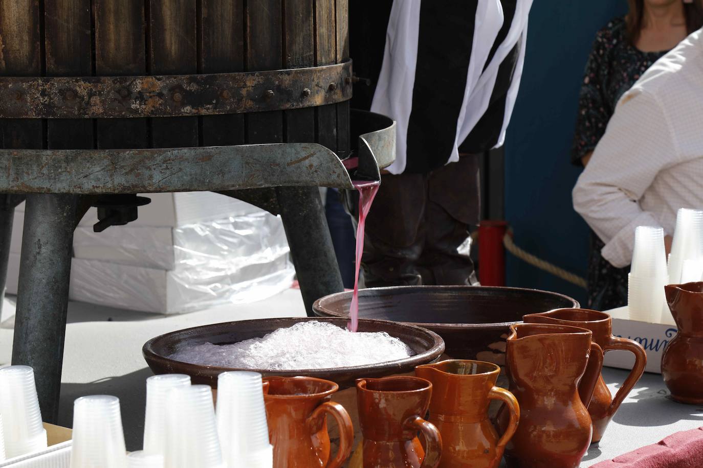 Dos niños pisan la uva para extraer el mosto en la plaza de Quintanilla.