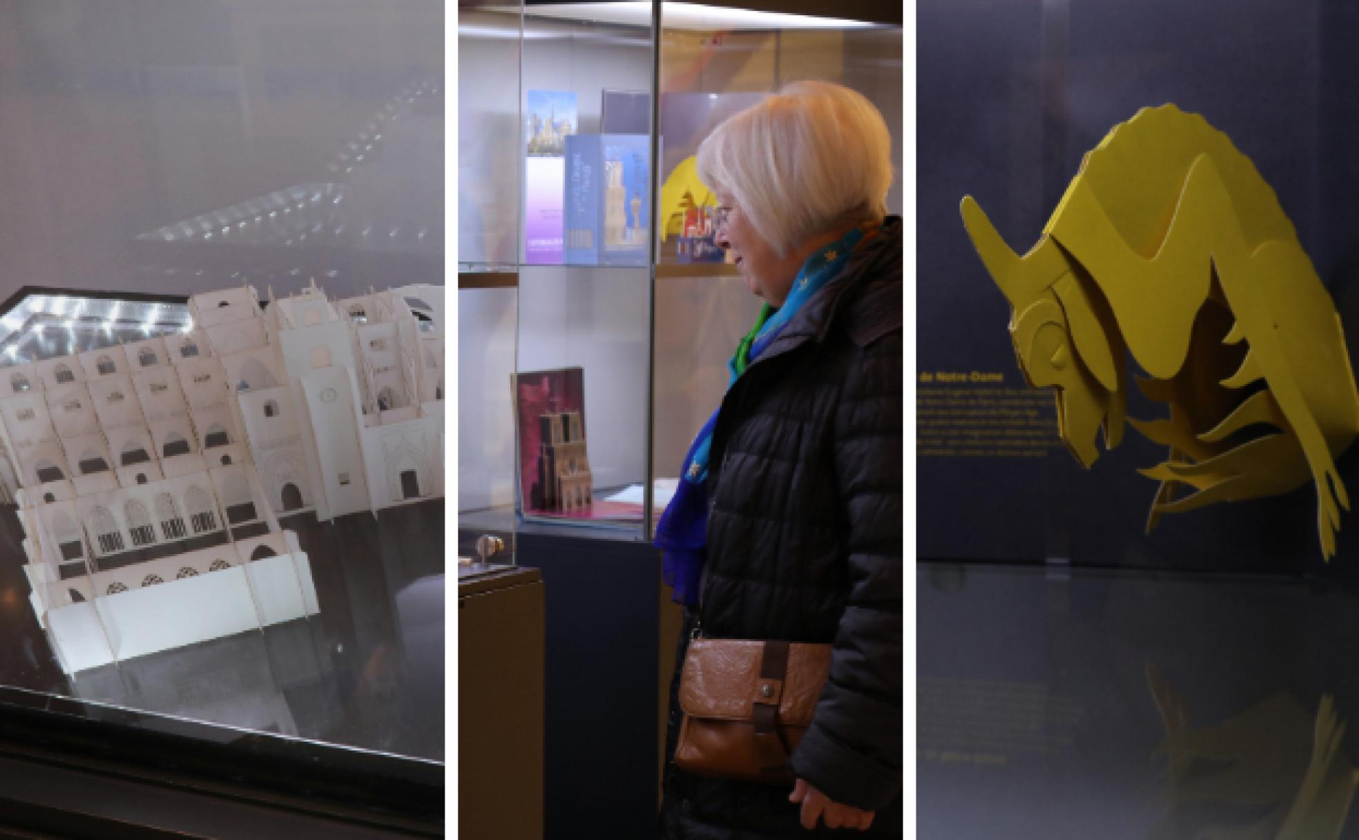 La Catedral de Palencia en papel, junto a una mujer que observa la exposición y una gargola de Notre Dame. 